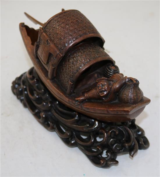 A Chinese bamboo model of a junk boat, with a stand carved as waves, late 19th/early 20th century, length 30cm